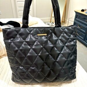 Black quilted tote with laptop sleeve insert.